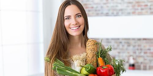 Woman holding bag of vegetables